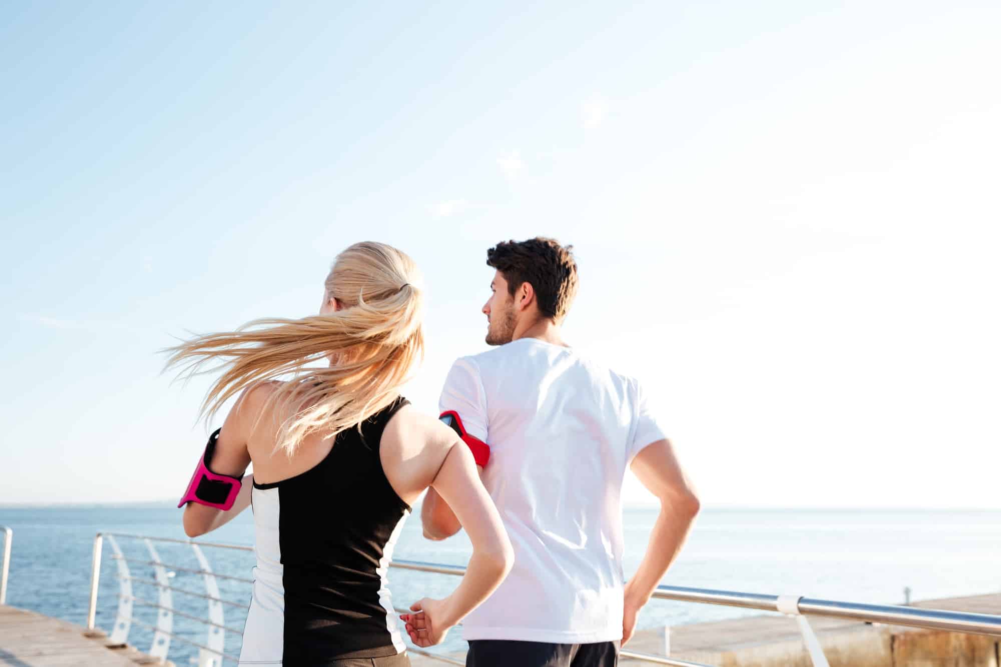 Back view of a couple exercising for marathon